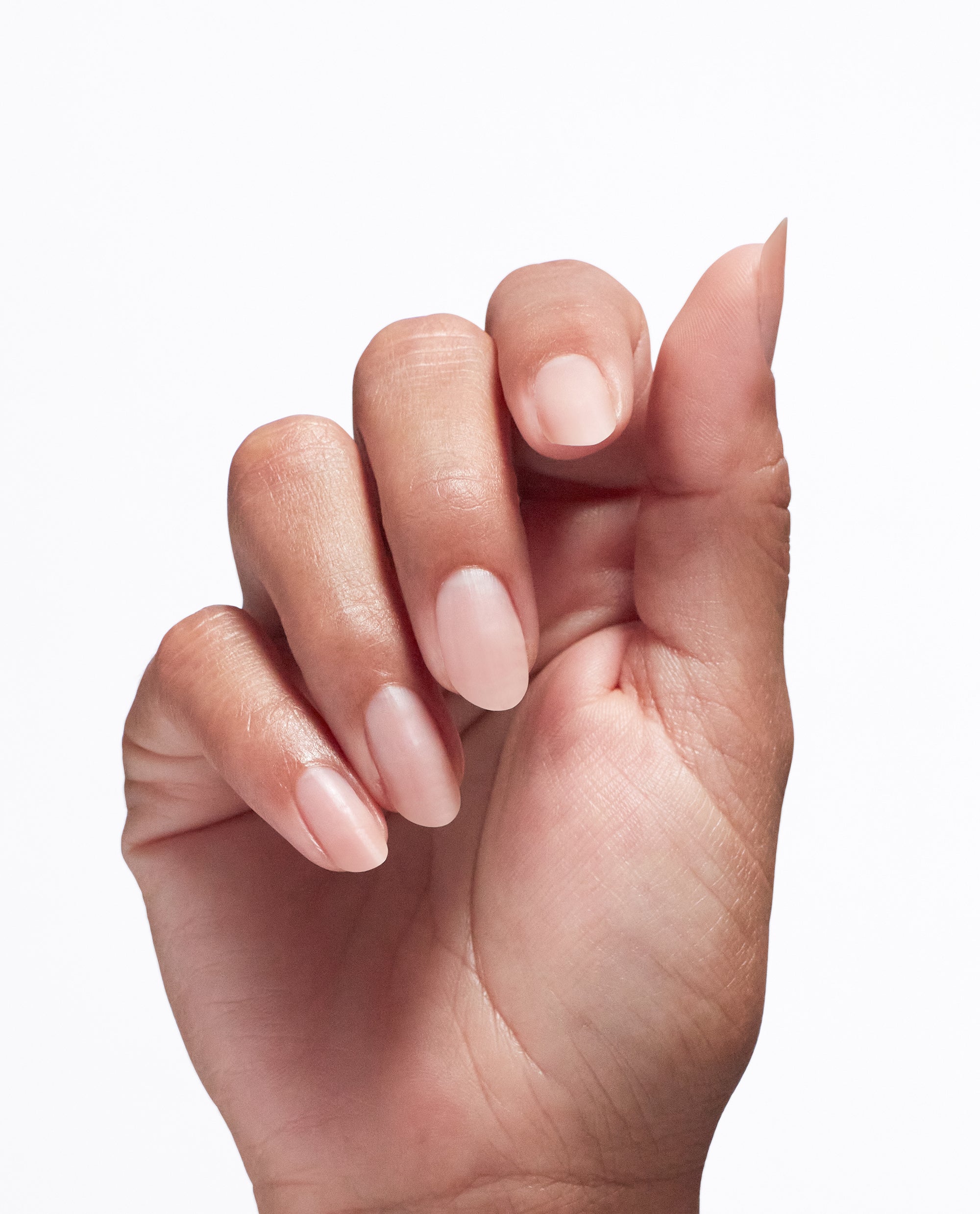 Hand with smooth, healthy natural nails held in a loose curl, showcasing the glossy, sheer finish achieved using Repair Mode™ Bond Building Nail Serum treatment, ideal as a strengthening base for an OPI nail polish gift set on a clean white background.